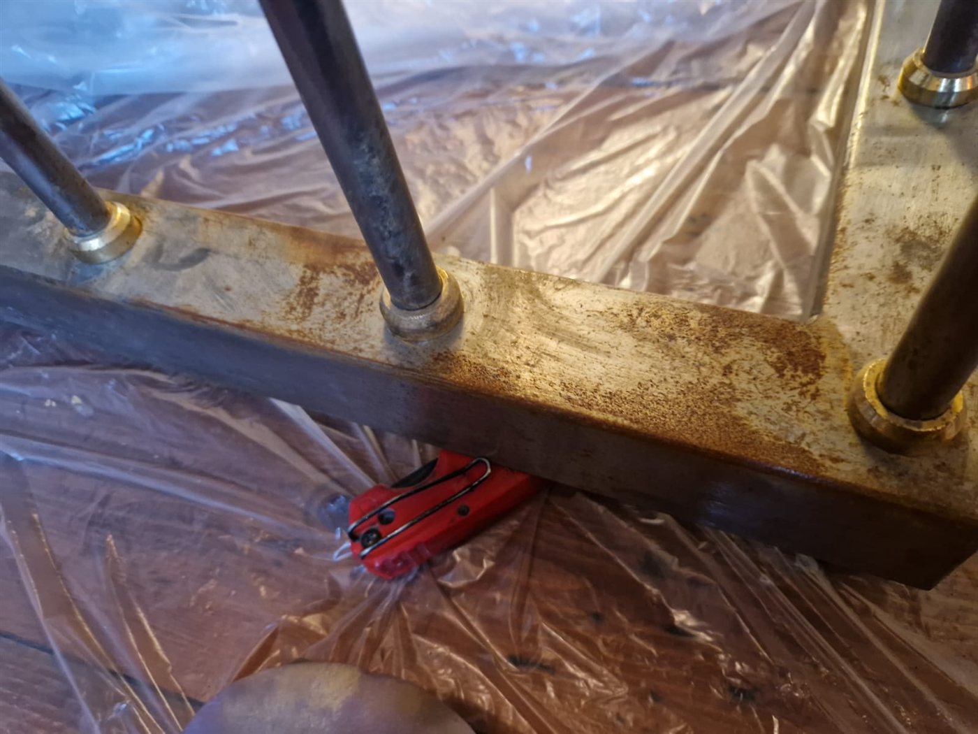 The fender base on dust sheets, with rust still showing