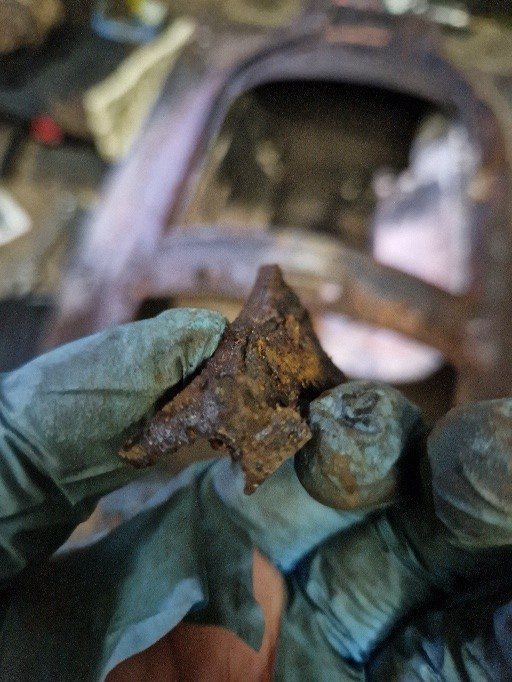 The damaged section of cast iron that had broken away