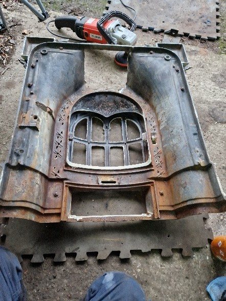 The rusted back of the enamel faceplate