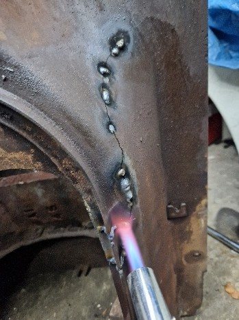 Heat-treating the cast iron with a torch