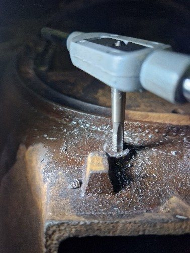 Re-tapping the drilled-out bolt holes
