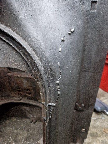 Stitch welds along the outside of the crack