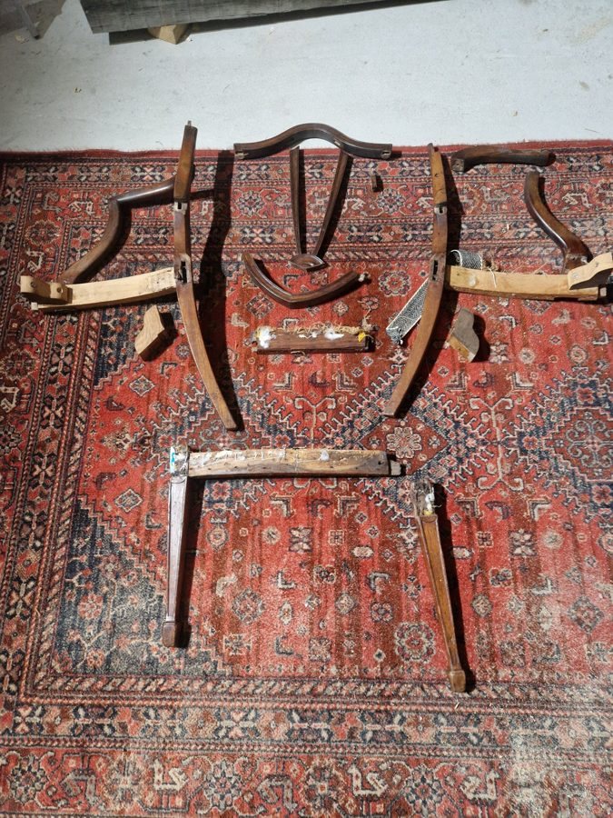 The chair frame fully dismantled and laid out
