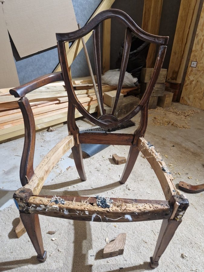 The frame stripped back to bare timber